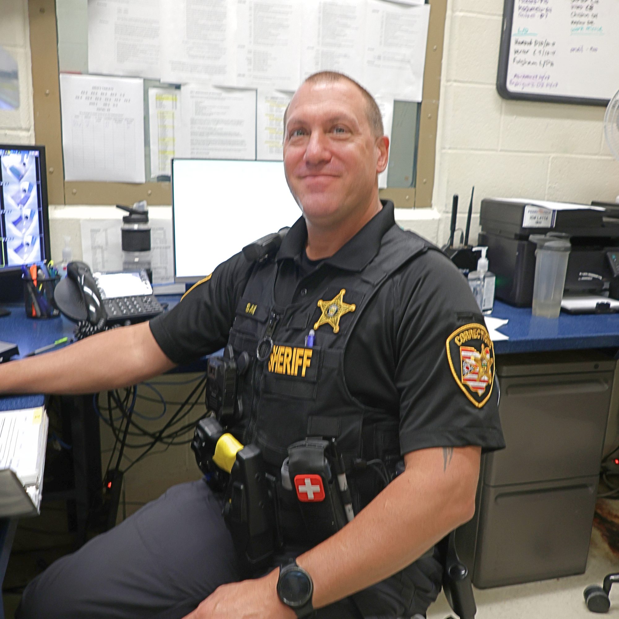 Corrections officer at a desk.